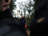 Michel Forst is speaking on the phone while policemen are arresting an 'Ecureuil' in a tree in a very dangerous situation in Saix, France, o...