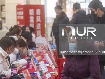 Job seekers are learning about jobs at a job fair in Taizhou, East China's Jiangsu province, on February 25, 2024. (