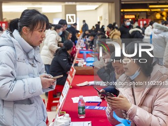 Job seekers are consulting at a large-scale job fair in Taizhou, East China's Jiangsu Province, on February 25, 2024. (