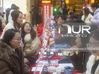 Job seekers are consulting at a large-scale job fair in Taizhou, East China's Jiangsu Province, on February 25, 2024. (