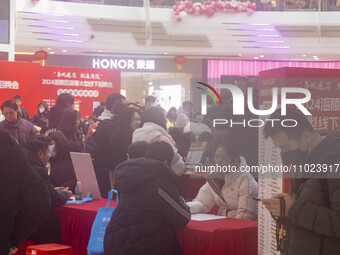 Job seekers are consulting at a large-scale job fair in Taizhou, East China's Jiangsu Province, on February 25, 2024. (