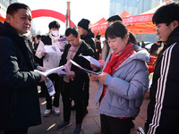 Job seekers are learning about job openings at a booth of an employment company at a spring job fair for SMEs in Liaocheng, China, on Februa...