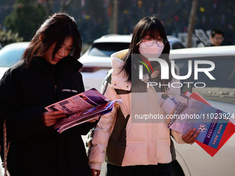 Job seekers are looking for suitable positions at a spring job fair for SMEs in Liaocheng, China, on February 25, 2024. (