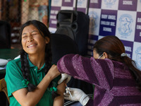 A Nepali student is reacting as a paramedic administers a vaccine against measles-rubella at a local school in Kathmandu, Nepal, on February...