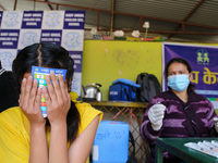 A Nepali student is reacting as a paramedic administers a vaccine against measles-rubella at a local school in Kathmandu, Nepal, on February...