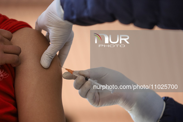 A Nepali paramedic is administering a vaccine against measles-rubella at a local school in Kathmandu, Nepal, on February 25, 2024. Nepal lau...