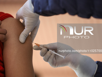 A Nepali paramedic is administering a vaccine against measles-rubella at a local school in Kathmandu, Nepal, on February 25, 2024. Nepal lau...