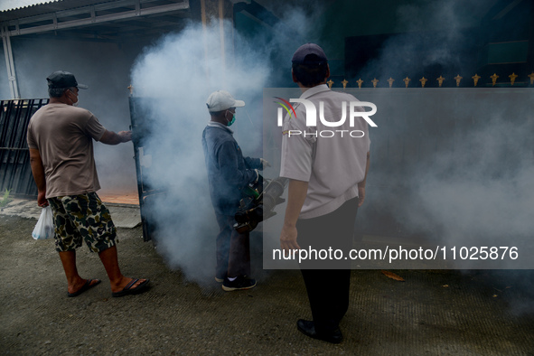 A worker is fumigating an area with anti-mosquito fog to control dengue fever in a residential area in Bogor, West Java, Indonesia, on Febru...