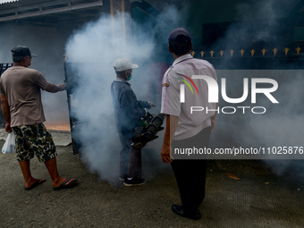 A worker is fumigating an area with anti-mosquito fog to control dengue fever in a residential area in Bogor, West Java, Indonesia, on Febru...