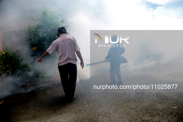 A worker is fumigating an area with anti-mosquito fog to control dengue fever in a residential area in Bogor, West Java, Indonesia, on Febru...