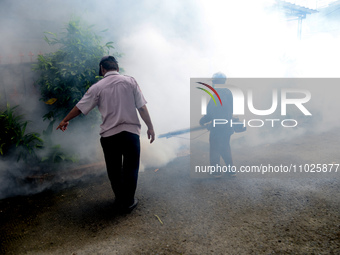 A worker is fumigating an area with anti-mosquito fog to control dengue fever in a residential area in Bogor, West Java, Indonesia, on Febru...