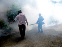 A worker is fumigating an area with anti-mosquito fog to control dengue fever in a residential area in Bogor, West Java, Indonesia, on Febru...