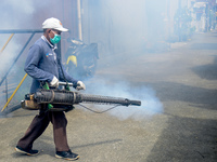 A worker is fumigating an area with anti-mosquito fog to control dengue fever in a residential area in Bogor, West Java, Indonesia, on Febru...