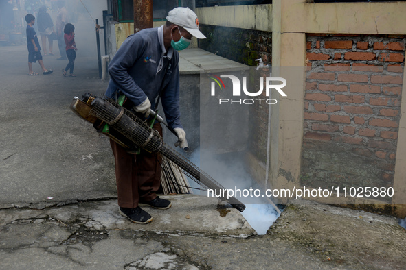 A worker is fumigating an area with anti-mosquito fog to control dengue fever in a residential area in Bogor, West Java, Indonesia, on Febru...