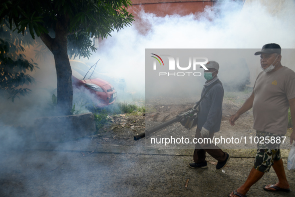 A worker is fumigating an area with anti-mosquito fog to control dengue fever in a residential area in Bogor, West Java, Indonesia, on Febru...