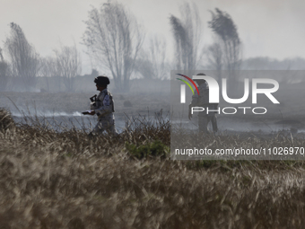 Members of the National Guard are guarding the area where a fire occurred in the Cuemanco Ecological Park in Xochimilco, Mexico City. (