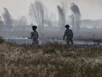 Members of the National Guard are guarding the area where a fire occurred in the Cuemanco Ecological Park in Xochimilco, Mexico City. (