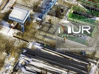 Workers are working at the construction site of Mixheng City in Huai'an, China, on February 25, 2024. (