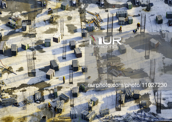 Workers are working at the construction site of Mixheng City in Huai'an, China, on February 25, 2024. 