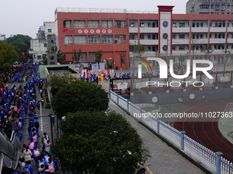 Primary school students are lining up to enter the campus at the start of the new semester in Yichang, Hubei Province, China, on February 26...