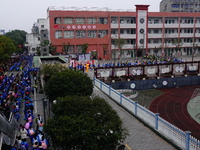 Primary school students are lining up to enter the campus at the start of the new semester in Yichang, Hubei Province, China, on February 26...