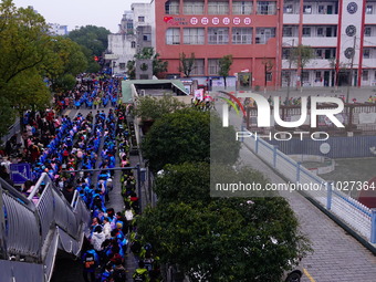 Primary school students are lining up to enter the campus at the start of the new semester in Yichang, Hubei Province, China, on February 26...