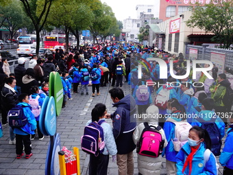 Primary school students are lining up to enter the campus at the start of the new semester in Yichang, Hubei Province, China, on February 26...