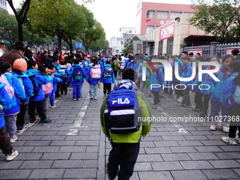 Primary school students are lining up to enter the campus at the start of the new semester in Yichang, Hubei Province, China, on February 26...