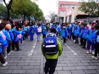 Primary school students are lining up to enter the campus at the start of the new semester in Yichang, Hubei Province, China, on February 26...