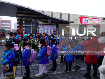 Primary school students are lining up to enter the campus at the start of the new semester in Yichang, Hubei Province, China, on February 26...