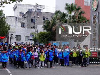 Primary school students are lining up to enter the campus at the start of the new semester in Yichang, Hubei Province, China, on February 26...