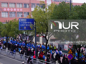 Primary school students are lining up to enter the campus at the start of the new semester in Yichang, Hubei Province, China, on February 26...