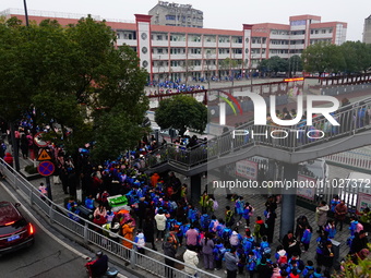 Primary school students are lining up to enter the campus at the start of the new semester in Yichang, Hubei Province, China, on February 26...