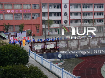 Primary school students are lining up to enter the campus at the start of the new semester in Yichang, Hubei Province, China, on February 26...