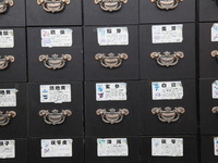 Traditional Chinese medicine cabinets, labeled with the names of various herbs, and hanging medicine scales are being seen in Shantou, Guang...