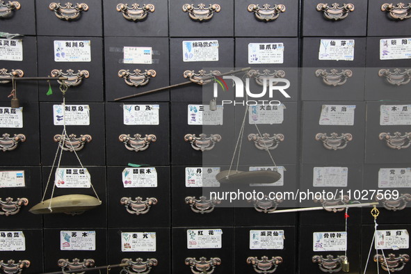 Traditional Chinese medicine cabinets, labeled with the names of various herbs, and hanging medicine scales are being seen in Shantou, Guang...