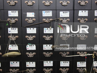 Traditional Chinese medicine cabinets, labeled with the names of various herbs, and hanging medicine scales are being seen in Shantou, Guang...