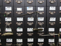 Traditional Chinese medicine cabinets, labeled with the names of various herbs, and hanging medicine scales are being seen in Shantou, Guang...