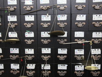 Traditional Chinese medicine cabinets, labeled with the names of various herbs, and hanging medicine scales are being seen in Shantou, Guang...