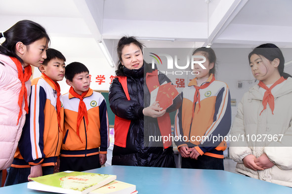 A teacher (3rd from the right) is explaining the Constitution of the Communist Party of China (CPC) to students in Zaozhuang, China, on Febr...