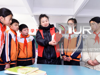 A teacher (3rd from the right) is explaining the Constitution of the Communist Party of China (CPC) to students in Zaozhuang, China, on Febr...