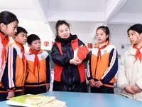 A teacher (3rd from the right) is explaining the Constitution of the Communist Party of China (CPC) to students in Zaozhuang, China, on Febr...