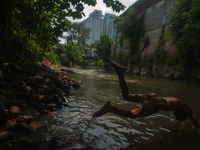 Children are playing in the polluted Babura River, which is contaminated with plastic waste, in Medan, North Sumatra, Indonesia, on February...