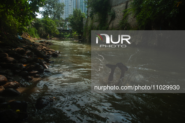 Children are playing in the polluted Babura River, which is contaminated with plastic waste, in Medan, North Sumatra, Indonesia, on February...