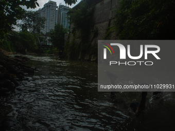 Children are playing in the polluted Babura River, which is contaminated with plastic waste, in Medan, North Sumatra, Indonesia, on February...