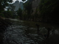 Children are playing in the polluted Babura River, which is contaminated with plastic waste, in Medan, North Sumatra, Indonesia, on February...