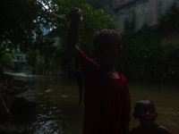 Children are playing in the polluted Babura River, which is contaminated with plastic waste, in Medan, North Sumatra, Indonesia, on February...