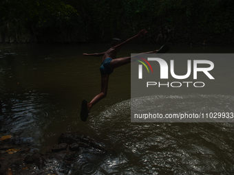 Children are playing in the polluted Babura River, which is contaminated with plastic waste, in Medan, North Sumatra, Indonesia, on February...