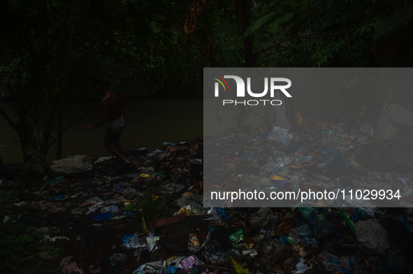 Children are playing in the polluted Babura River, which is contaminated with plastic waste, in Medan, North Sumatra, Indonesia, on February...