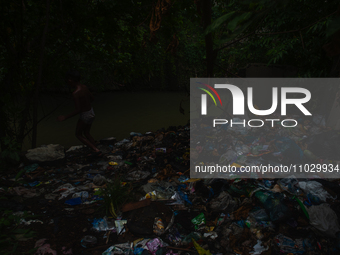 Children are playing in the polluted Babura River, which is contaminated with plastic waste, in Medan, North Sumatra, Indonesia, on February...